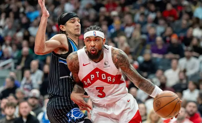Toronto Raptors forward Brandon Ingram (3) drives against Orlando Magic guard Anthony Black (left) during first half of an NBA game in Toronto on Monday Dec. 29, 2025. THE (Frank Gunn/The Canadian Press via AP)