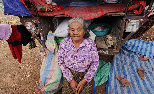 An evacuated elderly woman sits in a tent as she takes refuge in Batthkoa primary school in Oddar Meanchey province, Cambodia, Wednesday, Dec. 10, 2025, after fleeing home following a fighting between Thailand and Cambodia over territorial claims. (AP Photo/Heng Sinith)