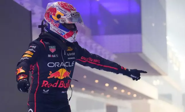 Red Bull driver Max Verstappen of the Netherlands celebrates after winning the Qatar Formula One Grand Prix, at the Lusail International Circuit, in Lusail, Qatar, Sunday, Nov. 30, 2025. (AP Photo/Darko Bandic)