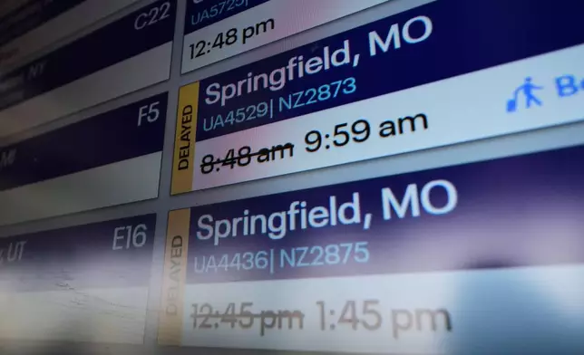 FILE - Flight times are displayed at O'Hare airport in Chicago, Tuesday, Dec. 23, 2025. (AP Photo/Nam Y. Huh, File)