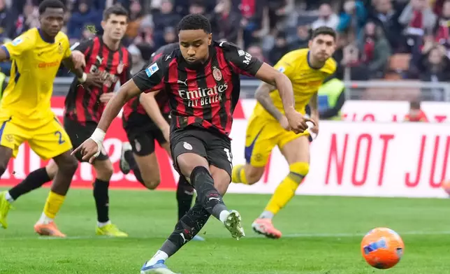 AC Milan's Christopher Nkunku scores his side's second goal from a penalty kick during a Serie A soccer match between AC Milan and Hellas Verona, in Milan, Italy, Sunday, Dec. 28, 2025. (AP Photo/Luca Bruno)