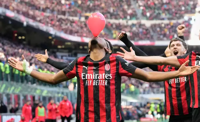 AC Milan's Christopher Nkunku celebrates after scoring his side's second goal from a penalty kick during a Serie A soccer match between AC Milan and Hellas Verona, in Milan, Italy, Sunday, Dec. 28, 2025. (AP Photo/Luca Bruno)