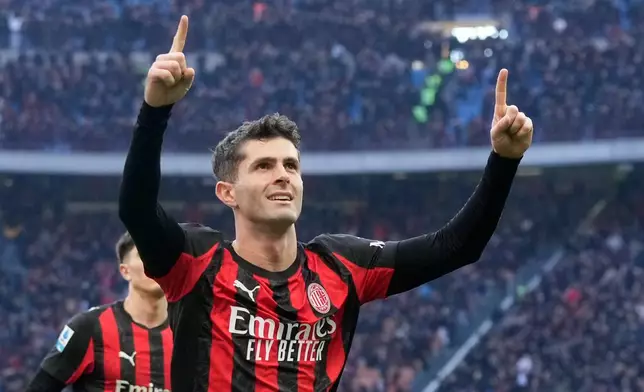 AC Milan's Christian Pulisic celebrates after scoring his side's first goal during a Serie A soccer match between AC Milan and Hellas Verona, in Milan, Italy, Sunday, Dec. 28, 2025. (AP Photo/Luca Bruno)