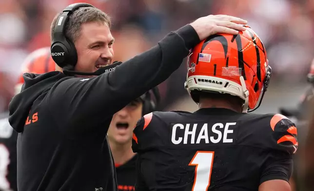 Cincinnati Bengals head coach Zac Taylor celebrates with wide receiver Ja'Marr Chase (1) after a touchdown during the first half of an NFL football game Sunday, Dec. 28, 2025, in Cincinnati. (AP Photo/Jeff Dean)