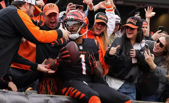 Cincinnati Bengals wide receiver Ja'Marr Chase celebrates with fans after scoring a touchdown during the first half of an NFL football game against the Arizona Cardinals, Sunday, Dec. 28, 2025, in Cincinnati. (AP Photo/Jeff Dean)