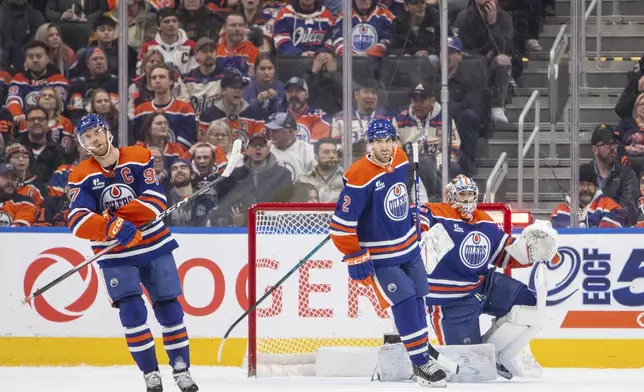 Edmonton Oilers Connor McDavid (97), Evan Bouchard (2), and goalie Stuart Skinner (74) react after losing to the Buffalo Sabres during overtime in an NHL hockey game in Edmonton, Alberta, Tuesday, Dec. 9, 2025. (Amber Bracken/The Canadian Press via AP)
