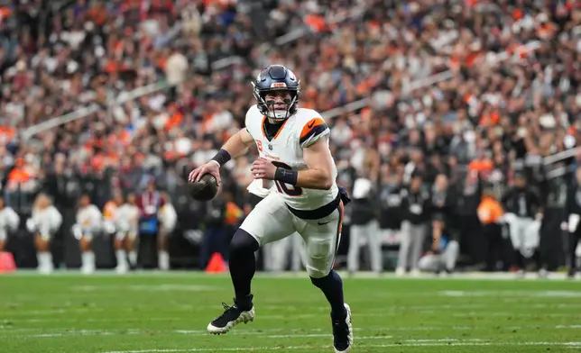 Denver Broncos quarterback Bo Nix rolls out of the pocket during the first half of an NFL football game against the Las Vegas Raiders in Las Vegas, Sunday, Dec. 7, 2025. (AP Photo/Candice Ward)