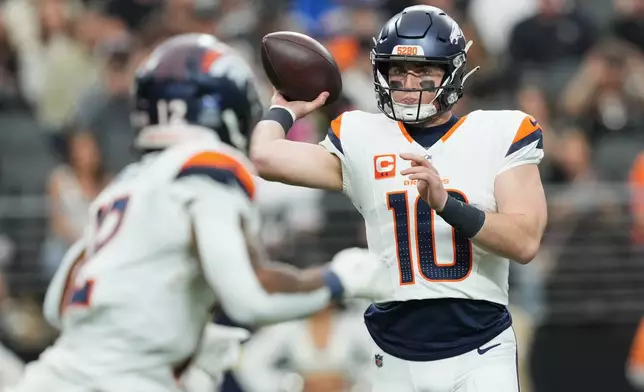 Denver Broncos quarterback Bo Nix (10) passes against the Las Vegas Raiders during the first half of an NFL football game in Las Vegas, Sunday, Dec. 7, 2025. (AP Photo/Candice Ward)