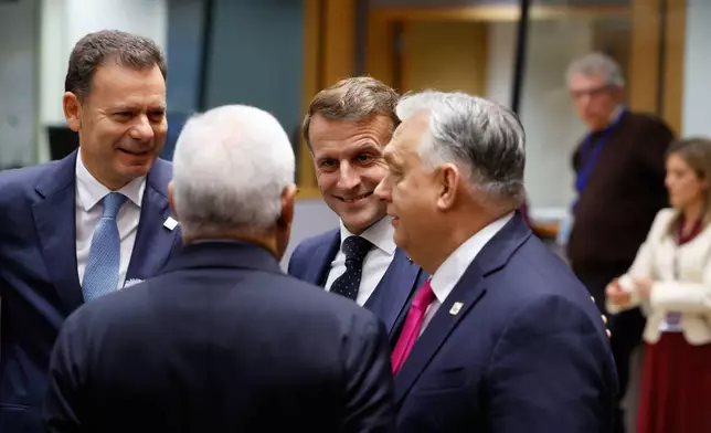 From left, Portugal's Prime Minister Luis Montenegro, European Council President Antonio Costa, French President Emmanuel Macron and Hungary's Prime Minister Viktor Orban during a round table meeting at the EU Summit in Brussels, Thursday, Dec. 18, 2025. (AP Photo/Geert Vanden Wijngaert)