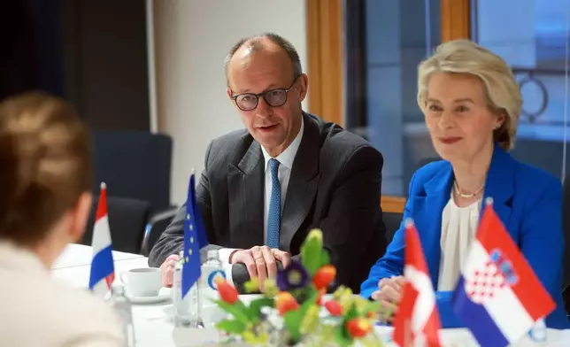 European Commission President Ursula von der Leyen, right, and Germany's Chancellor Friedrich Merz, left, attend a round table meeting on migration at the EU Summit in Brussels, Thursday, Dec. 18, 2025. (AP Photo/Olivier Hoslet, Pool Photo via AP)
