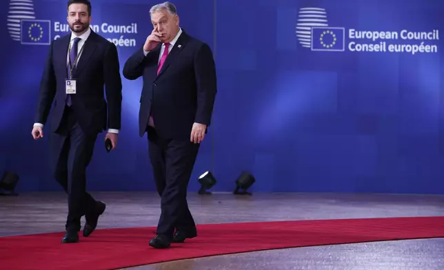Hungary's Prime Minister Viktor Orban, right, arrives for the EU Summit in Brussels, Thursday, Dec. 18, 2025. (AP Photo/Omar Havana)