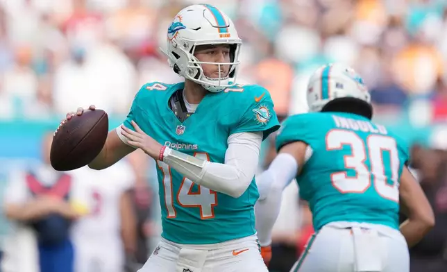 Miami Dolphins quarterback Quinn Ewers (14) looks to pass against the Tampa Bay Buccaneers during the first half of an NFL football game Sunday, Dec. 28, 2025, in Miami Gardens, Fla. (AP Photo/Rebecca Blackwell)