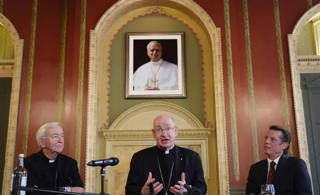 From left, outgoing archbishop of Westminster Cardinal Vincent Nichols, Bishop Richard Moth and the cardinal's press secretary Alexander des Forges sit, during a press conference announcing Bishop Moth as the new Archbishop, replacing Cardinal Nichols as the leader of the Catholic Church in England and Wales, in the Throne Room of Archbishop's House, Westminster, London, Friday, Dec. 19, 2025. (Jonathan Brady/PA via AP)