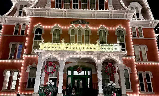People gather at Norwich City Hall, decorated for the annual "Light Up City Hall" event in Norwich, Conn., Friday, Dec. 5, 2025. Scenes from Hallmark movie Sugar Plum Twist were filmed at City Hall. (AP Photo/Susan Haigh)