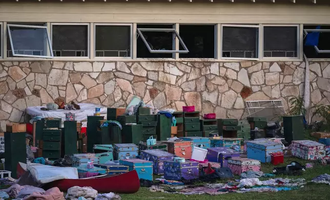 FILE - The belongings of campers sit outside one of Camp Mystic's cabins near the Guadalupe River in Hunt, Texas, July 7, 2025, after a deadly flash flood swept through the area. (AP Photo/Eli Hartman, File)