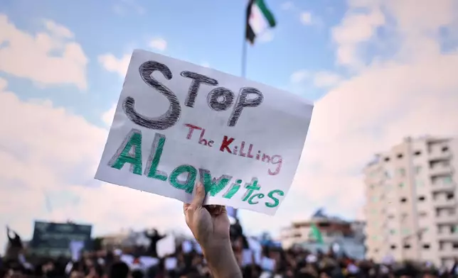 Protesters from the Alawite religious minority demonstrate two days after a bomb in an Alawite mosque in Homs killed eight people and wounded 18 during Friday prayers, in Latakia, Syria's coastal region, Sunday, Dec. 28, 2025. (AP Photo/Omar Albam)