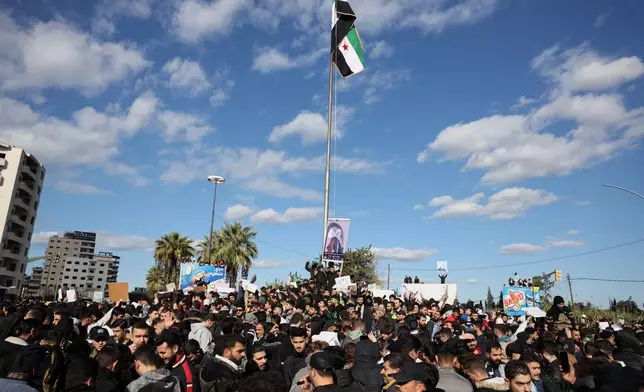Protesters from the Alawite religious minority demonstrate two days after a bomb in an Alawite mosque in Homs killed eight people and wounded 18 during Friday prayers, in Latakia, Syria's coastal region, Sunday, Dec. 28, 2025. (AP Photo/Omar Albam)