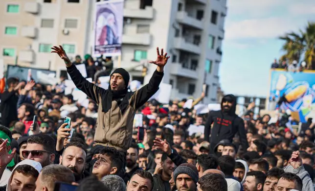 Protesters from the Alawite religious minority demonstrate two days after a bomb in an Alawite mosque in Homs killed eight people and wounded 18 during Friday prayers, in Latakia, Syria's coastal region, Sunday, Dec. 28, 2025. (AP Photo/Omar Albam)