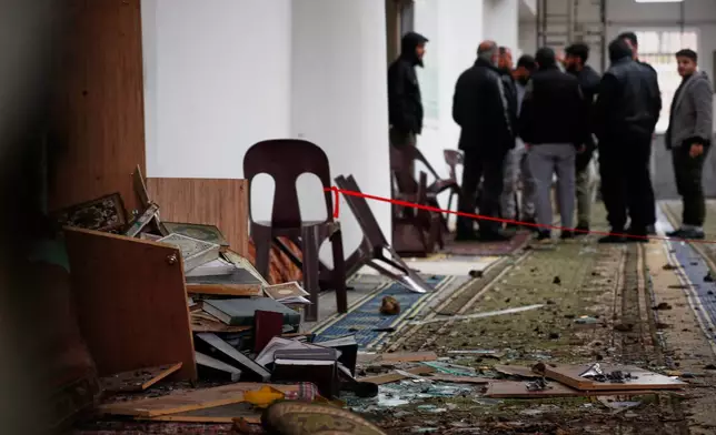 Syrian security officers inspect the site of an attack a day earlier at the Imam Ali bin Abi Talib Mosque in the predominantly Alawite Wadi al-Dhahab neighborhood of Homs, Syria, Saturday, Dec. 27, 2025. (AP Photo/Omar Sanadiki)