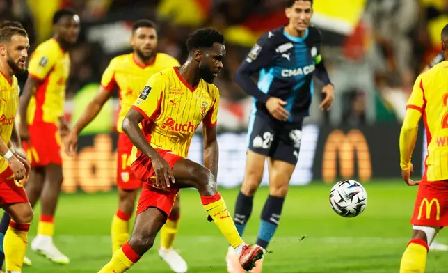 FILE - Lens' Odsonne Edouard kicks the ball during the French League One soccer match between Lens and Marseille in Lens, France, Saturday, Oct. 25, 2025. (AP Photo/Jean-Francois Badias, File)