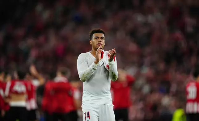 PSG's Desire Doue claps hands foe his team's supporters after the end of the Champions League opening phase soccer match between Athletic Bilbao and PSG in Bilbao, Spain, Wednesday, Dec.10, 2025. (AP Photo/Miguel Oses)