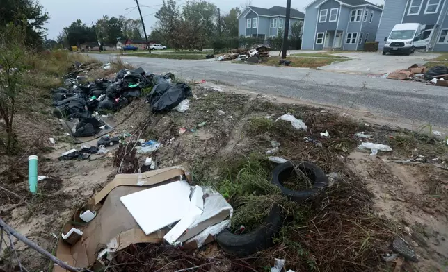 Piles of trash fill the ditch across a construction site in the Trinity Gardens neighborhood in northwest Houston, Thursday, Dec. 4, 2025. (AP Photo/Lekan Oyekanmi )