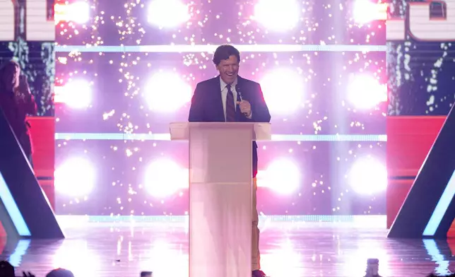 Tucker Carlson speaks during Turning Point USA's AmericaFest 2025, Thursday, Dec. 18, 2025, in Phoenix. (AP Photo/Jon Cherry)