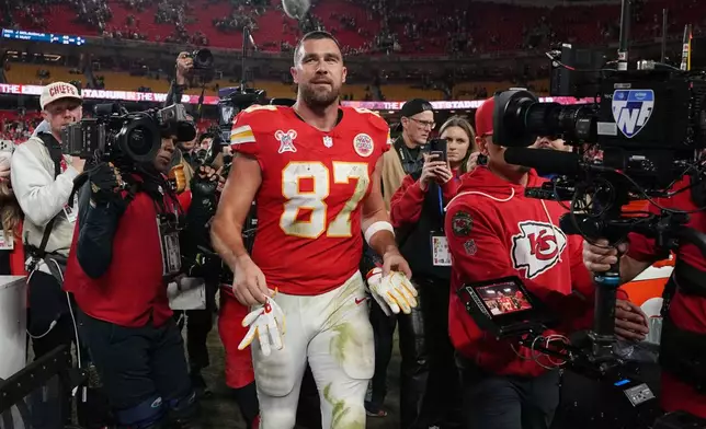 Kansas City Chiefs tight end Travis Kelce walks on the field following an NFL football game against the Denver Broncos Thursday, Dec. 25, 2025, in Kansas City. (AP Photo/Ed Zurga)
