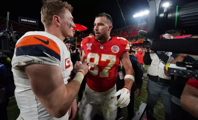 Denver Broncos quarterback Bo Nix, left, talks with Kansas City Chiefs tight end Travis Kelce following an NFL football game Thursday, Dec. 25, 2025, in Kansas City. (AP Photo/Ed Zurga)