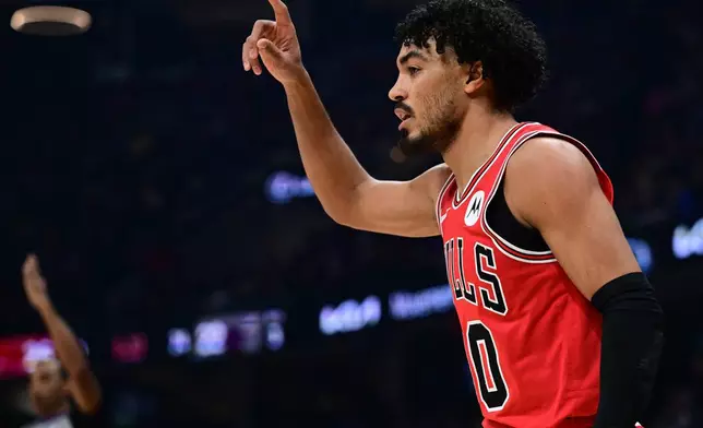 Chicago Bulls guard Coby White reacts after making a three-point basket in the first half of an NBA basketball game against the Cleveland Cavaliers, Friday, Dec. 19, 2025, in Cleveland. (AP Photo/David Dermer)
