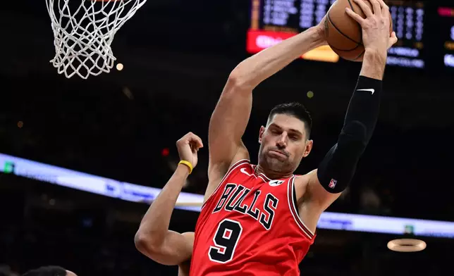 Chicago Bulls center Nikola Vucevic rebounds in the second half of an NBA basketball game against the Cleveland Cavaliers, Friday, Dec. 19, 2025, in Cleveland. (AP Photo/David Dermer)