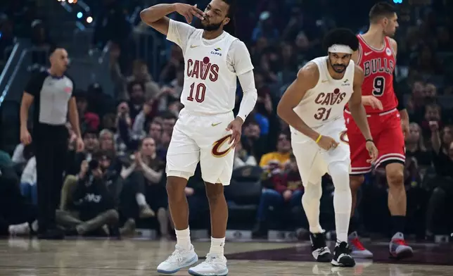 Cleveland Cavaliers guard Darius Garland celebrates after making a three-point basket in the first half of an NBA basketball game against the Chicago Bulls, Friday, Dec. 19, 2025, in Cleveland. (AP Photo/David Dermer)