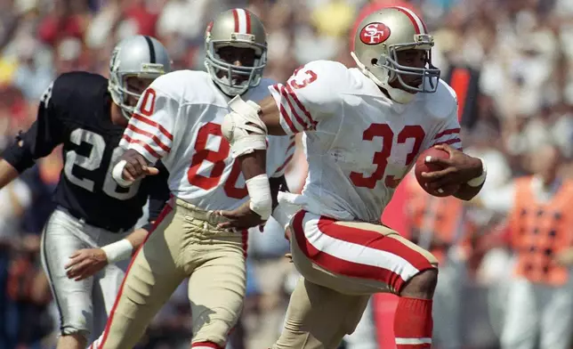 FILE - San Francisco 49ers Roger Craig (33) heads for the end zone for a first-quarter touchdown during an NFL football game against the Los Angeles Raiders at the Coliseum in Los Angeles, Sunday, Sept. 22, 1985. (AP Photo/Doug Pizac, File)