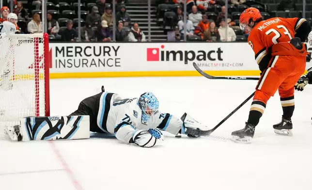 Utah Mammoth goaltender Karel Vejmelka, left, stops a shot by Anaheim Ducks center Mason McTavish during the third period of an NHL hockey game Wednesday, Dec. 3, 2025, in Anaheim, Calif. (AP Photo/Mark J. Terrill)