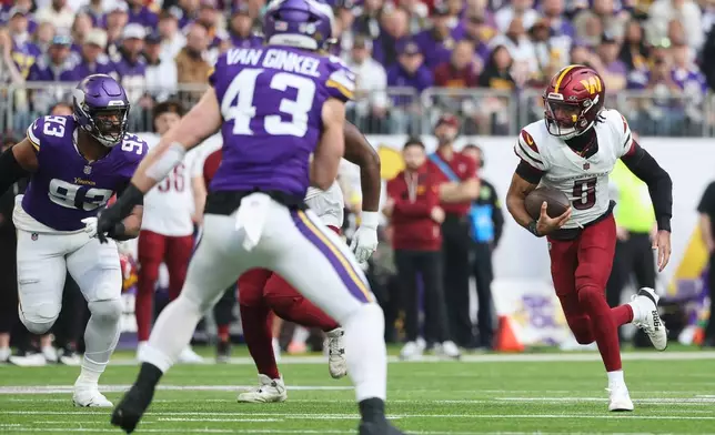 Washington Commanders quarterback Jayden Daniels (5) runs with the ball during the first half of an NFL football game against the Minnesota Vikings, Sunday, Dec. 7, 2025, in Minneapolis. (AP Photo/Matt Krohn)