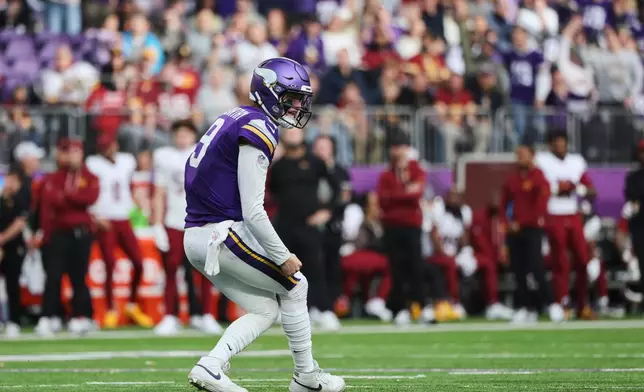 Minnesota Vikings quarterback J.J. McCarthy (9) reacts after throwing a touchdown during the second half of an NFL football game against the Washington Commanders, Sunday, Dec. 7, 2025, in Minneapolis. (AP Photo/Matt Krohn)