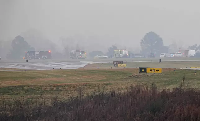 First responders tend to the scene of a reported plane crash at a regional airport in Statesville, N.C., Thursday, Dec. 18, 2025. (AP Photo/Matt Kelley)