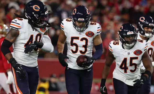 Chicago Bears linebacker T.J. Edwards (53) is congratulated by teammates after returning an interception for a touchdown during the first half of an NFL football game against the San Francisco 49ers in Santa Clara, Calif., Sunday, Dec. 28, 2025. (AP Photo/Jed Jacobsohn)