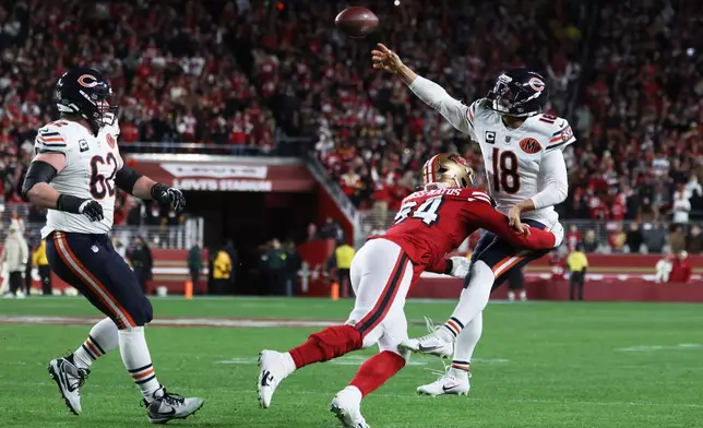 Chicago Bears quarterback Caleb Williams (18) passes while pressured by San Francisco 49ers defensive end Yetur Gross-Matos (94) on the final play of the second half of an NFL football game in Santa Clara, Calif., Sunday, Dec. 28, 2025. (AP Photo/Jed Jacobsohn)