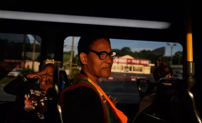 FILE - Derrick McNair-White, left, yawns next to Sechita McNair as they ride the city bus to Atlanta on June 11, 2025, in Jonesboro, Ga. (AP Photo/Brynn Anderson, File)