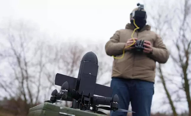 A serviceman prepares an interceptor drone of "General Cherry" company before a flight at the polygon in Ukraine, on Dec. 4, 2025. (AP Photo/Evgeniy Maloletka)
