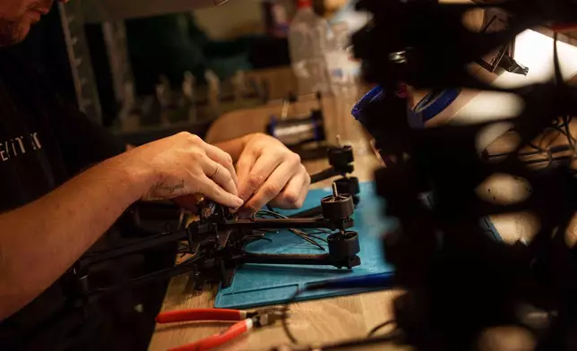 An engineer assembles FPV drone of "General Cherry" company at the workshop in Ukraine, on Dec. 4, 2025. (AP Photo/Evgeniy Maloletka)