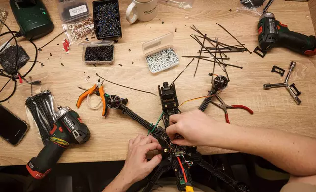 An engineer collects FPV drones of "General Cherry" company at the workshop in Ukraine, on Dec. 4, 2025. (AP Photo/Evgeniy Maloletka)