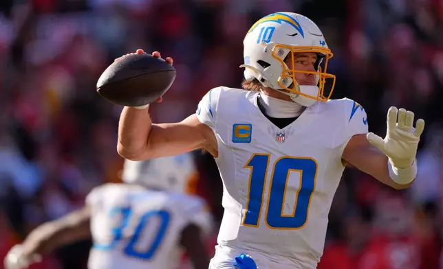 Los Angeles Chargers quarterback Justin Herbert throws during the first half of an NFL football game against the Kansas City Chiefs Sunday, Dec. 14, 2025, in Kansas City, Mo. (AP Photo/Charlie Riedel)
