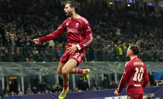 Liverpool's Dominik Szoboszlai celebrates after scoring his side's first goal from a penalty shot during a Champions League, league phase, soccer match between Inter Milan and Liverpool in Milan, Italy, Tuesday, Dec.9, 2025. (AP Photo/Luca Bruno)