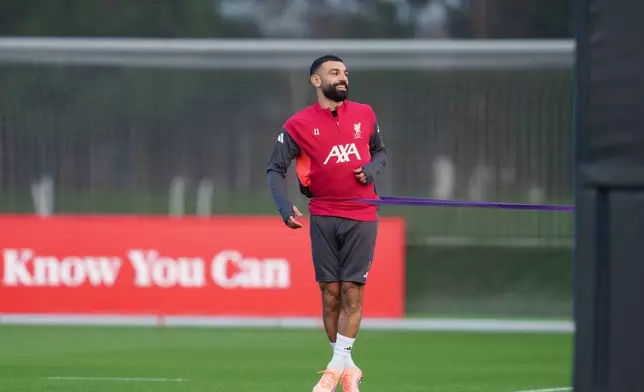 Liverpool's Mohamed Salah smiles as he takes part in a training session in Liverpool, England, Monday, Dec. 8, 2025. (AP Photo/Jon Super)
