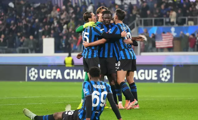 Atalanta players celebrate at the the end of the Champions League opening phase soccer match between Atalanta and Chelsea, in Bergamo, Italy, Tuesday, Dec. 9, 2025. (AP Photo/Antonio Calanni)