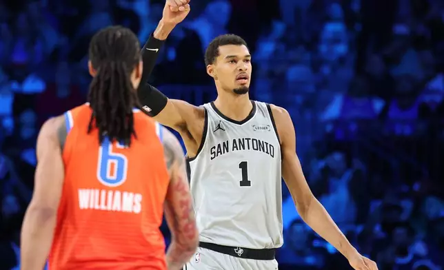San Antonio Spurs forward Victor Wembanyama (1) reacts to scoring in the second half of an NBA Cup semifinals basketball game against the Oklahoma City Thunder, Saturday, Dec. 13, 2025, in Las Vegas. (AP Photo/Ronda Churchill)