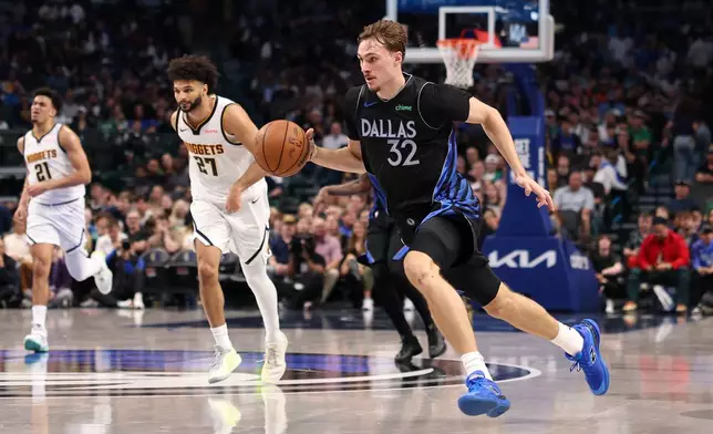 Dallas Mavericks forward Cooper Flagg (32) brings the ball up the court during the third quarter of an NBA basketball game against the Denver Nuggets Tuesday, Dec. 23, 2025, in Dallas. (AP Photo/Sam Hodde)