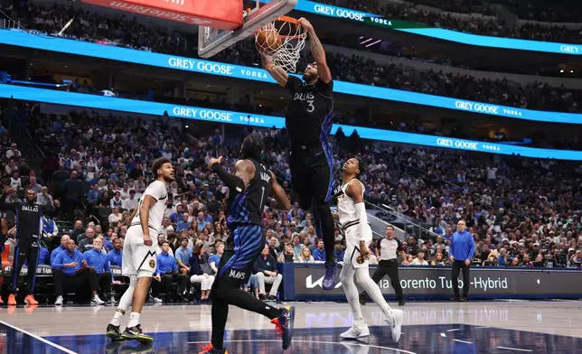 Dallas Mavericks forward Anthony Davis (3) dunks during the third quarter of an NBA basketball game against the Denver Nuggets Tuesday, Dec. 23, 2025, in Dallas. (AP Photo/Sam Hodde)